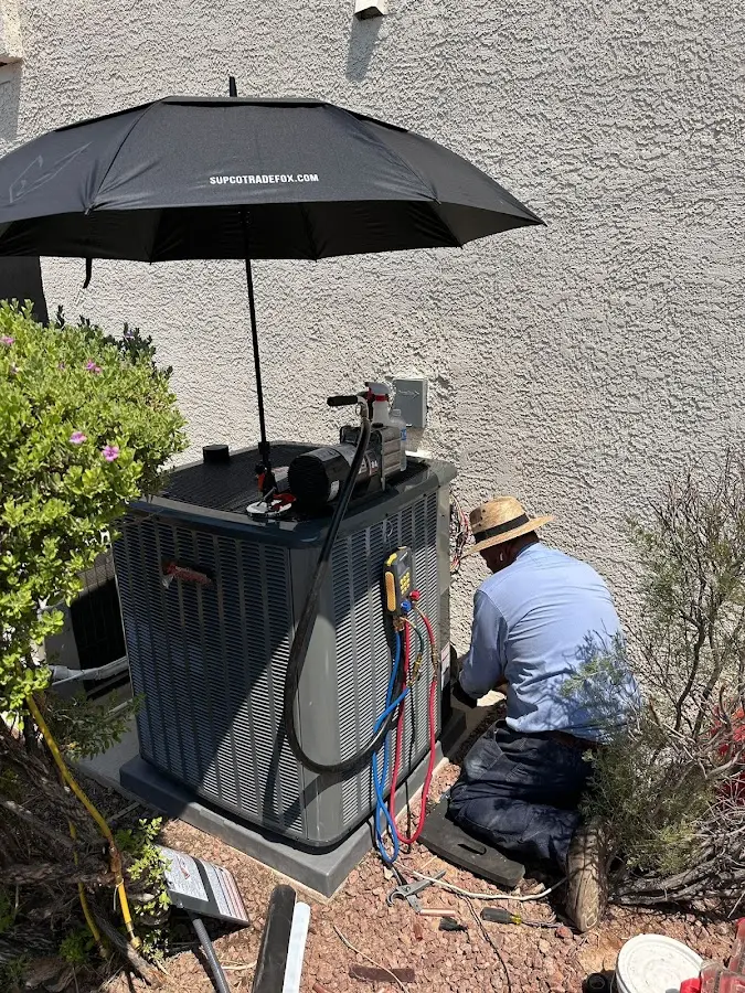 HVAC technician performing outdoor AC maintenance in Willowick